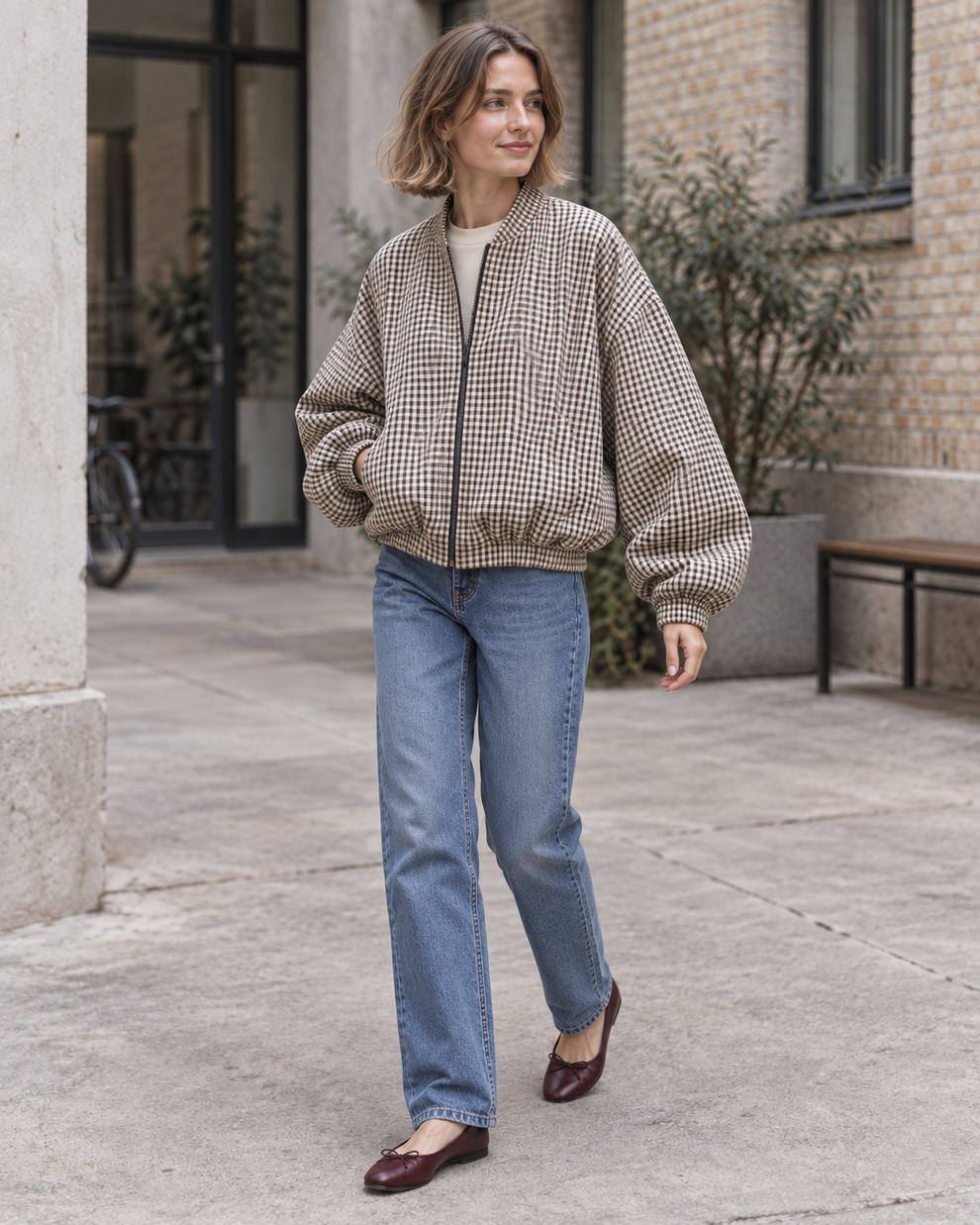 Three-quarter view of the checked cropped bomber